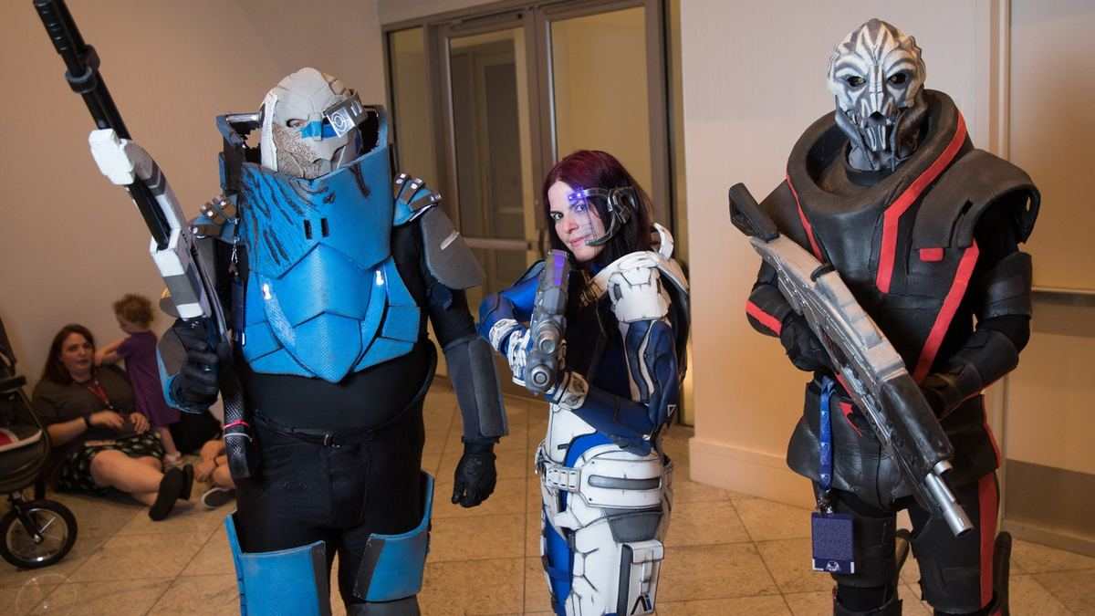 Cosplayers dressed as Mass Effect characters in armour and alien masks