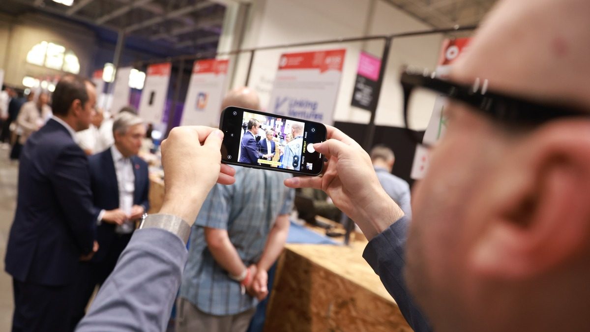 Finance Minister François-Philippe Champagne speaks with startups during a tour at Collision 2023 in Toronto