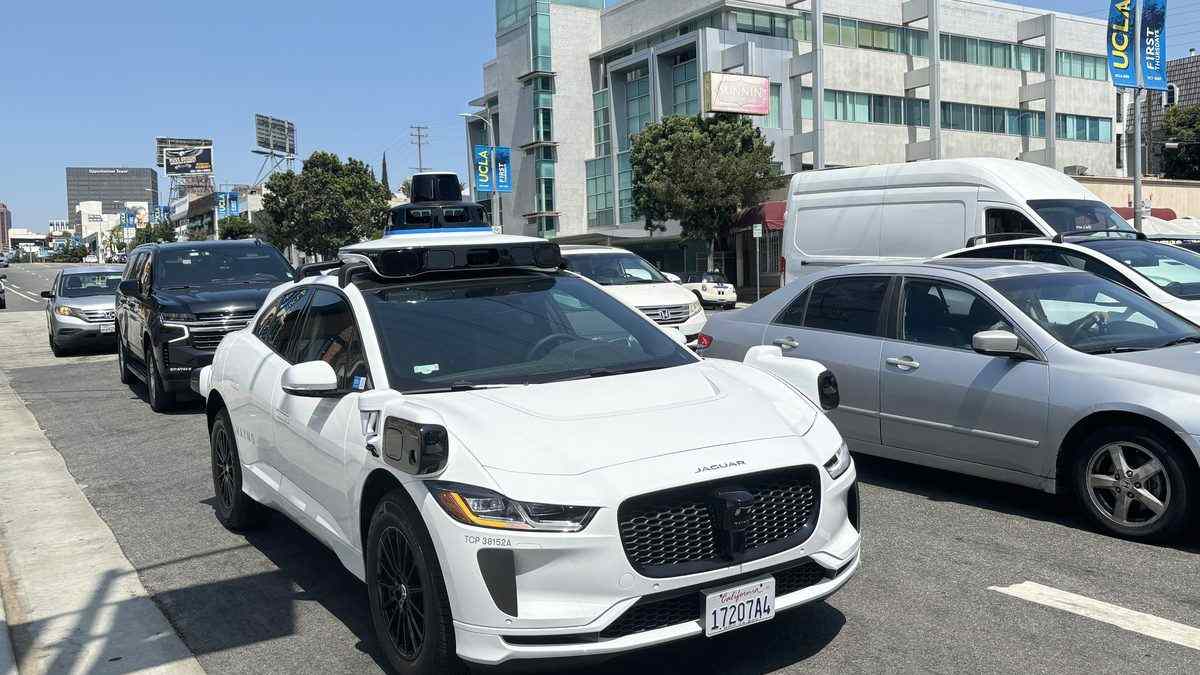 A Waymo Jaguar I-PACE self-driving test vehicle with its rooftop sensor array