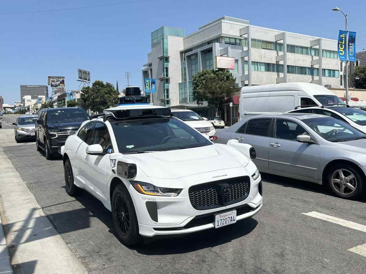 A Waymo Jaguar I-PACE self-driving test vehicle with its rooftop sensor array